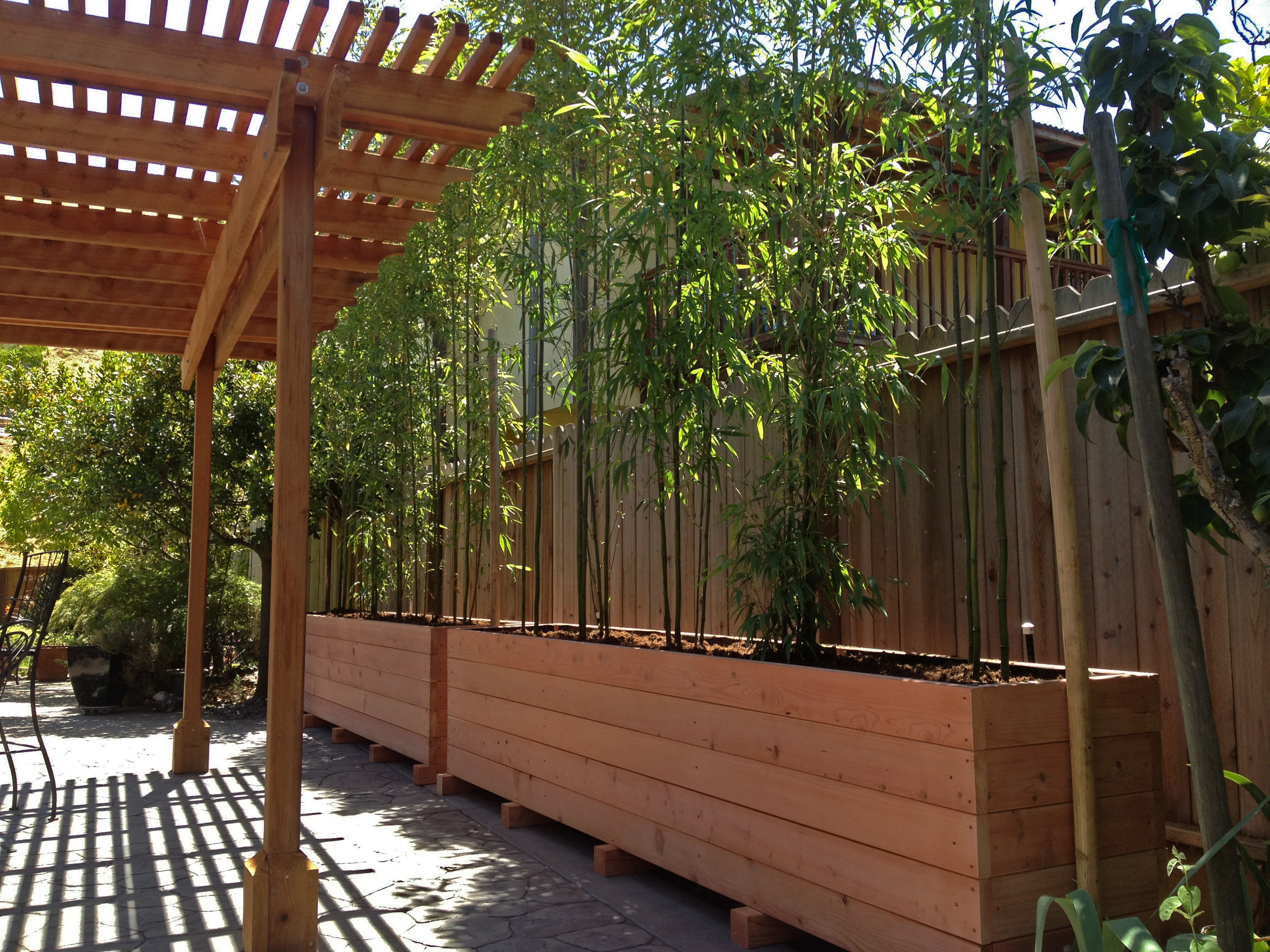 Pressure-treated planter box with bamboo